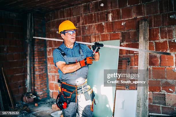 construction worker on building site - plumber tool bag stock pictures, royalty-free photos & images