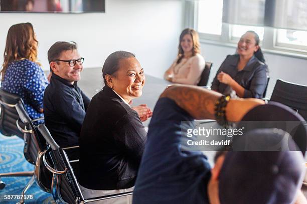 successful maori pacific islander business woman leading a team meeting - new zealand stock pictures, royalty-free photos & images