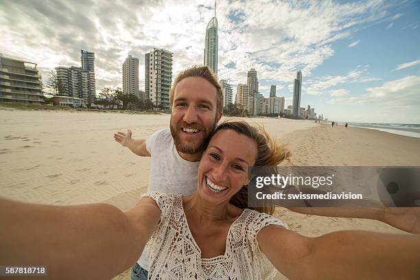 caucasian couple take a selfie portrait at surfer's paradise beach - city to surf stock pictures, royalty-free photos & images