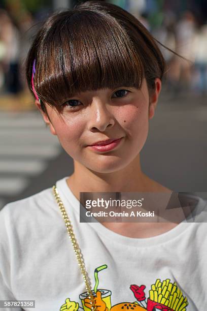 Harajuku, Tokyo Ami Ito is seen on Meiji St. Wearing a white WeGo graphic tee, a black skirt by Seshirumakuri, white wedge sandals by Spins, and a...