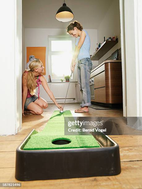 two women playing golf - mini golf stock-fotos und bilder