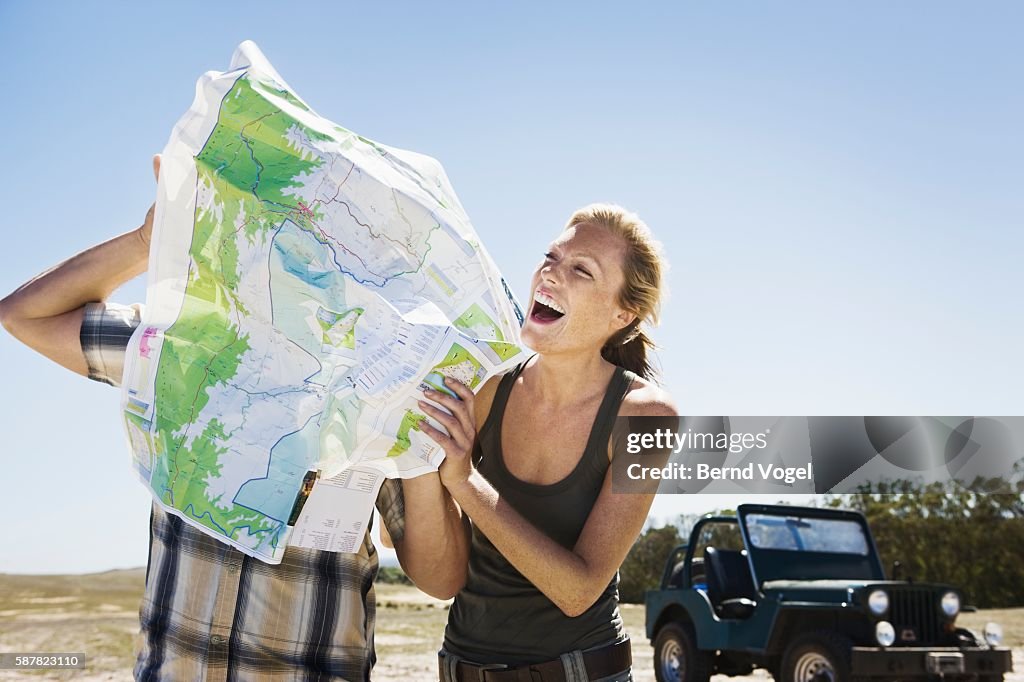 Playful Couple Looking at Map