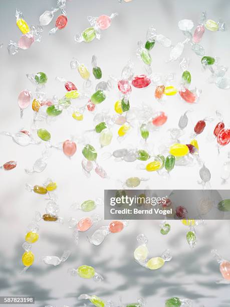 hard candies flying - hard candy stock pictures, royalty-free photos & images