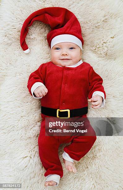 baby wearing santa claus costume - santa hat stock pictures, royalty-free photos & images