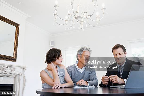 couple talking to a real estate agent - prosperity stock pictures, royalty-free photos & images