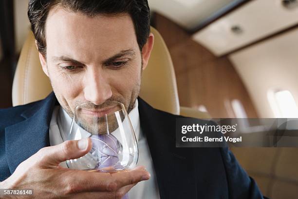 executive enjoying cognac - vehicle seat stock pictures, royalty-free photos & images