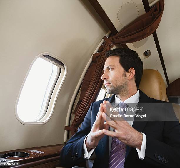 businessman on corporate airplane - private wealth stock pictures, royalty-free photos & images