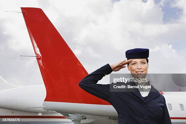 flight attendant saluting - saluting stock-fotos und bilder