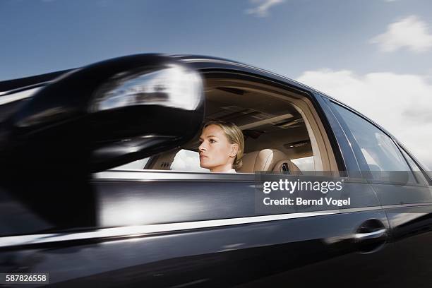 woman driving car - car profile stock pictures, royalty-free photos & images