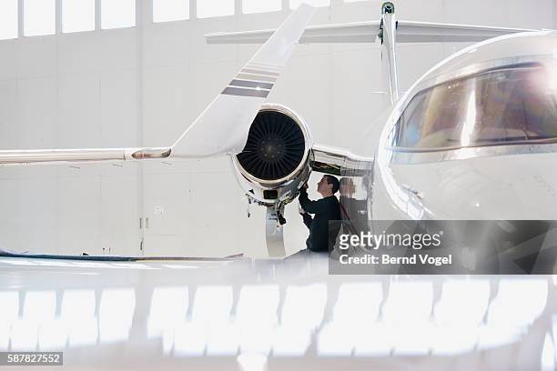aviation mechanic repairing jet engine - jet engine stock pictures, royalty-free photos & images