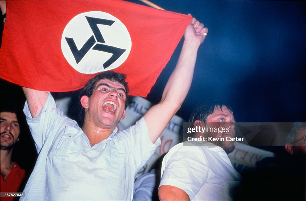 White South African man holds up a flag for the Afrikaner