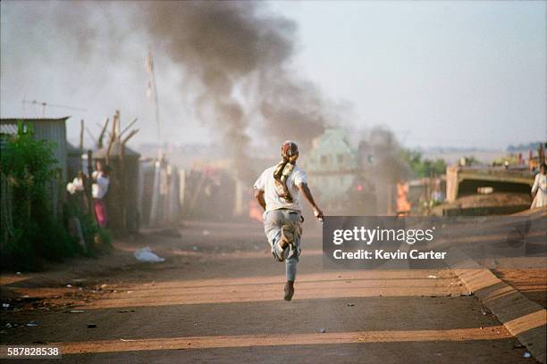 Members of the ANC stage an attack against Inkatha Freedom Party members during a funeral for one of their own. The incident left one IFP member dead...