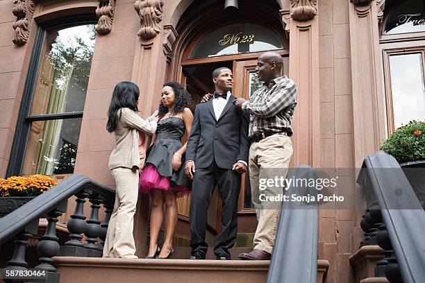 couple going to prom with parents on front stoop - mother and daughter smoking stock-fotos und bilder