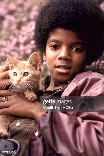 Portrait of Michael Jackson with a cat from a magazine shoot.