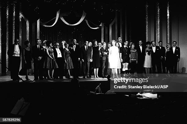 Celebrities on stage for the finale of a variety performance, London, circa 1965. Line up includes Bruce Foryth, Helen Shapiro and Adam Faith.