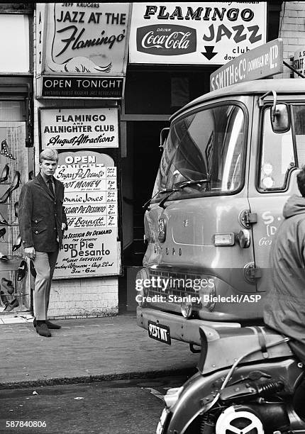 Model poses in the street outside the Flamingo club in Soho wearing Cecil Gee clothes for 'Mods Monthly' magazine, London, circa 1965.