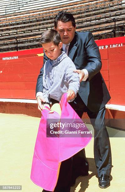 The Spanish bullfighter Vicente Ruiz 'El Soro' with his son Tito in the bullring of Valencia Spain. .