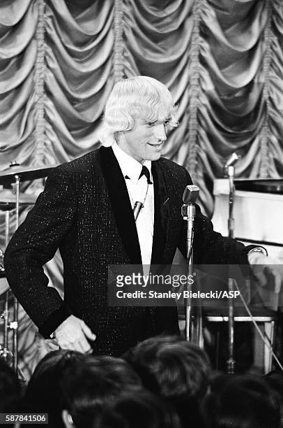 Jimmy Savile, as the compere, introduces Gerry & The Pacemakers during rehearsals of the talent show scenes for Jeremy Summers' musical film, 'Ferry...