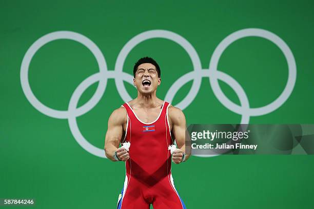 Myong Hyok Kim of Republic of Korea competes during the Men's 69kg Group A Weightlifting contest on Day 4 of the Rio 2016 Olympic Games at the...