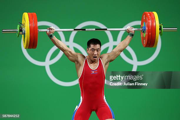 Myong Hyok Kim of Republic of Korea competes during the Men's 69kg Group A Weightlifting contest on Day 4 of the Rio 2016 Olympic Games at the...