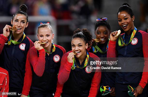 Gold medalists Alexandra Raisman, Madison Kocian, Lauren Hernandez, Simone Biles and Gabrielle Douglas of the United States pose for photographs on...