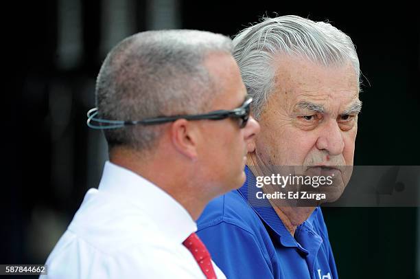 Kansas City Royals' owner David Glass talks with general manager Dayton Moore as they watch the Royals take batting practice prior to a game against...