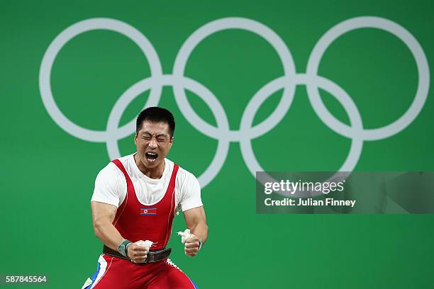 Myong Hyok Kim of Republic of Korea celebrates during the Men's 69kg Group A Weightlifting contest on Day 4 of the Rio 2016 Olympic Games at the...