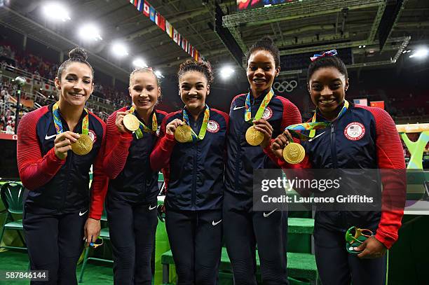 Gold medalists Alexandra Raisman, Madison Kocian, Lauren Hernandez, Gabrielle Douglas and Simone Biles of the United States pose for photographs with...