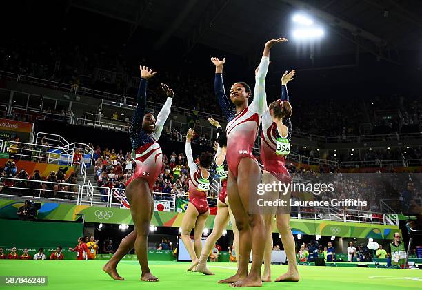 Simone Biles, Lauren Hernandez, Alexandra Raisman, Gabrielle Douglas and Madison Kocian of the United States celebrate winning the gold medal during...