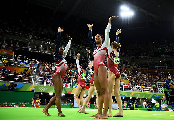 Simone Biles, Lauren Hernandez, Alexandra Raisman, Gabrielle Douglas and Madison Kocian of the United States celebrate winning the gold medal during...