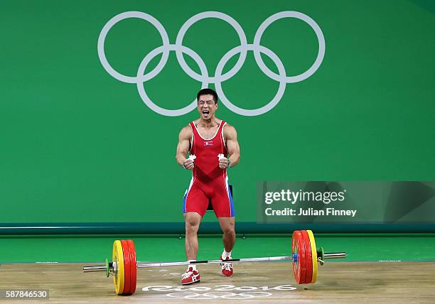 Myong Hyok Kim of Republic of Korea competes during the Men's 69kg Group A Weightlifting contest on Day 4 of the Rio 2016 Olympic Games at the...