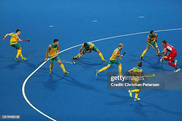 Chris Ciriello of Australia shoots the ball against Jerome Truyens of Belgium during the hockey game on Day 4 of the Rio 2016 Olympic Games at the...