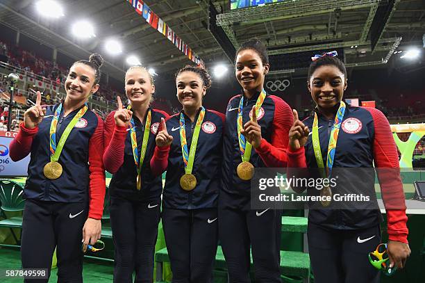 Gold medalists Alexandra Raisman, Madison Kocian, Lauren Hernandez, Gabrielle Douglas and Simone Biles of the United States pose for photographs with...