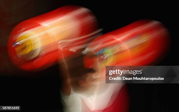 Myong Hyok Kim of Republic of Korea competes after the Men's 69kg Group A Weightlifting contest on Day 4 of the Rio 2016 Olympic Games at the...