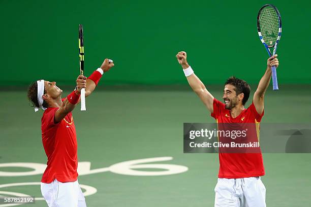 Rafael Nadal and Marc Lopez of Spain celebrate defeating Oliver Marach and Alexander Peya of Austria in a Men's Doubles Quarterfinals match on Day 4...