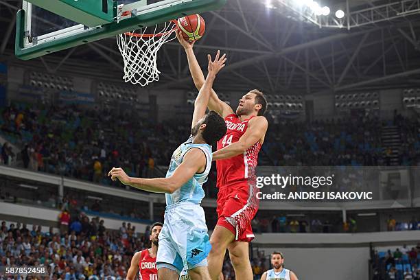 Croatia's shooting guard Bojan Bogdanovic goes to the basket despite Argentina's shooting guard Patricio Garino during a Men's round Group B...