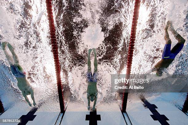 Michael Phelps of the United States leads Chad le Clos of South Africa and Tamas Kenderesi of Hungary in the Men's 200m Butterfly Final on Day 4 of...