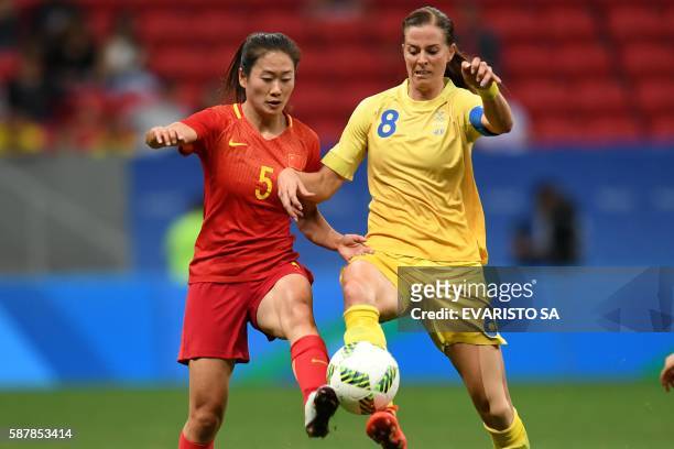 Sweden's player Lotta Schelin vies for the ball with China's player Wu Haiyan during their Rio 2016 Olympic Games first Round Group E women's...