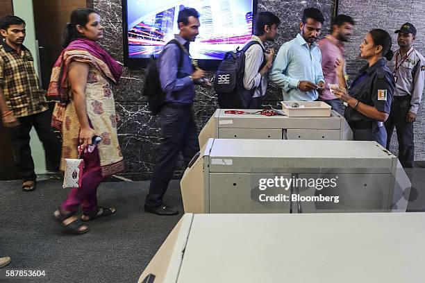 Security officer checks people entering the Bombay Stock Exchange building in Mumbai, India, on Tuesday, Aug. 9, 2016. Presiding over his final...