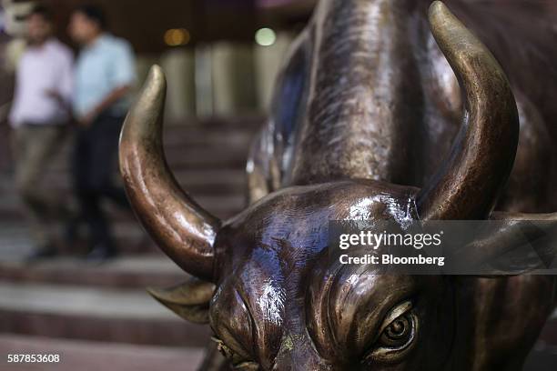 Bronze bull statue stands at the entrance to the Bombay Stock Exchange building in Mumbai, India, on Tuesday, Aug. 9, 2016. Presiding over his final...