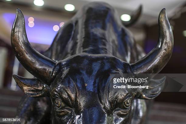 Bronze bull statue stands at the entrance to the Bombay Stock Exchange building in Mumbai, India, on Tuesday, Aug. 9, 2016. Presiding over his final...