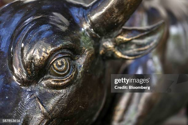 Bronze bull statue stands at the entrance to the Bombay Stock Exchange building in Mumbai, India, on Tuesday, Aug. 9, 2016. Presiding over his final...