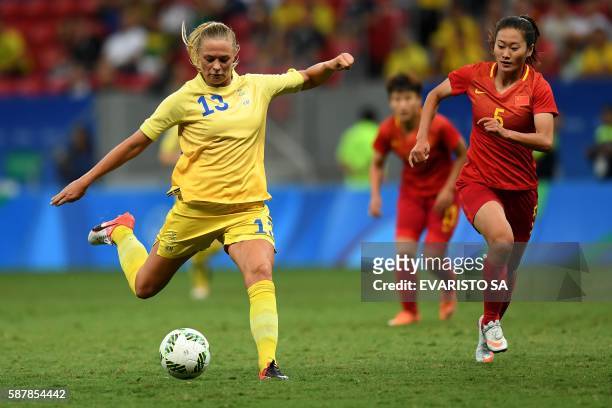 Sweden player Fridolina Rolfo prepares to kick the ball beside China's player Wu Haiyan during the Rio 2016 Olympic Games first Round Group E women's...