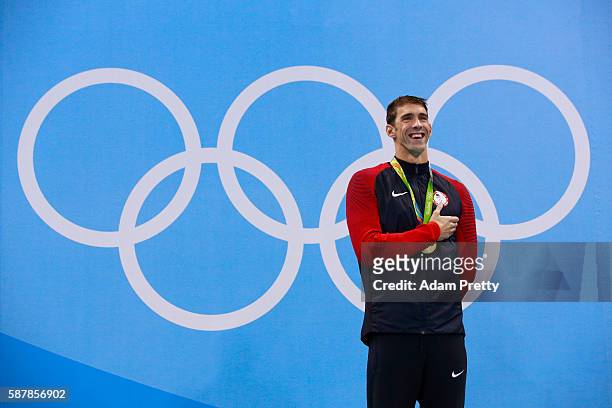 Gold medalist Michael Phelps of the United States poses on the podium during the medal ceremony for the Men's 200m Butterfly Final on Day 4 of the...