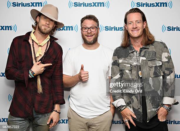 Brian Kelley and Tyler Hubbard of Florida Georgia Line pose for a photo with actor Seth Rogen during their visit to the SiriusXM Studios on August 8,...