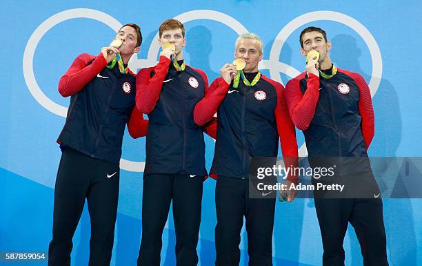 Gold medalist Townley Haas, Conor Dwyer, Ryan Lochte and Michael Phelps of the United States celebrate on the podium during the medal presentation...