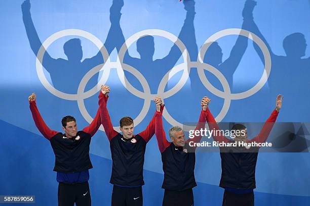Gold medalist Townley Haas, Conor Dwyer, Ryan Lochte and Michael Phelps of the United States celebrate on the podium during the medal presentation...