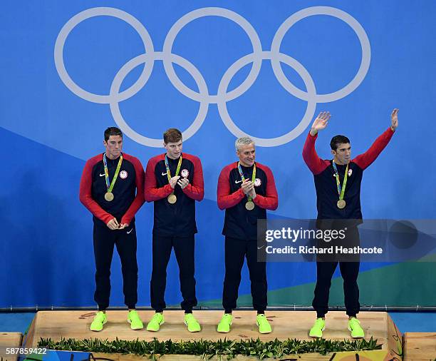 Gold medalist Townley Haas, Conor Dwyer, Ryan Lochte and Michael Phelps of the United States celebrate on the podium during the medal presentation...