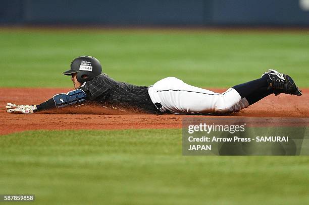 Ryosuke Kikuchi of Japan slides safely into the third base in the top of fourth inning during the international friendly match between Japan and...