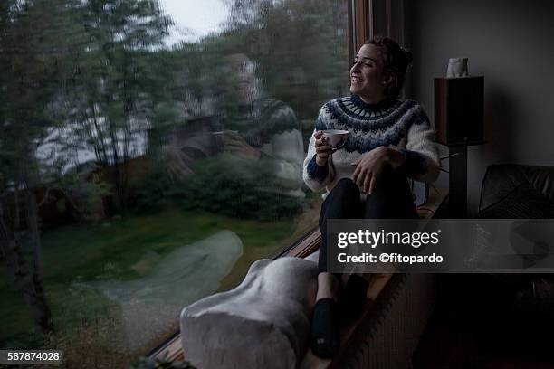 melancholy, one woman watching the trees from inside - watching thunderstorm stock pictures, royalty-free photos & images